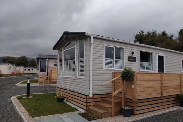 Plantation shutters fitted in the bay window of a static caravan on a holiday park